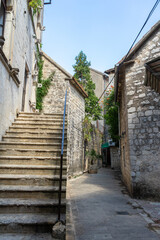 Narrow street among the stone houses of the ancient city of Kotor, Montenegro
