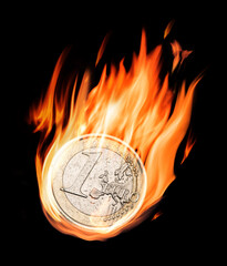 Burning one euro coin in flames on the black background.