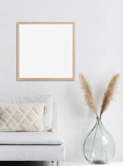 Blank frame mockup in modern interior design with trendy vase and sofa on empty white wall background, Square template for paintings, photo or poster. Artwork mock-up.