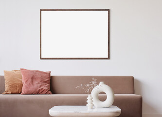 Blank frame mockup in modern interior design with trendy vase and sofa on empty white wall background, Horizontal template for paintings, photo or poster. Artwork mock-up © kite_rin