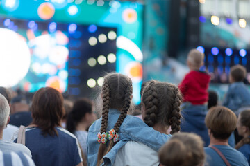 A concert on the street in the city with a large number of people.
