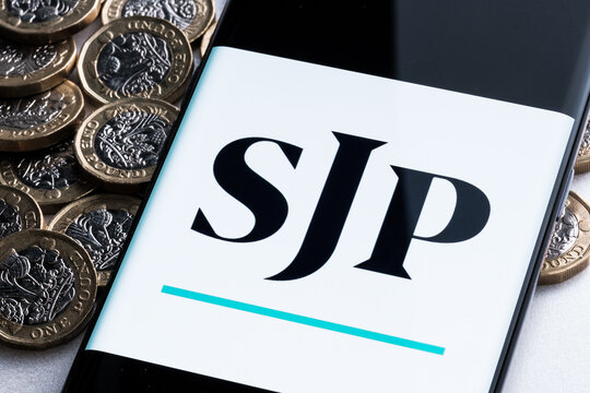 SJP application seen on smartphone screen placed on british pound coins. St. James's Place (SJP) is an Expert Financial Advice company. Stafford, United Kingdom, August 29, 2022.