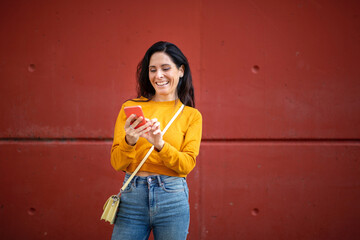 Stylish woman messaging using mobile phone