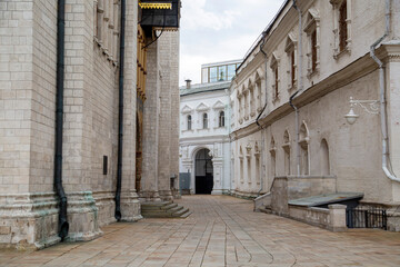 The alley between the buildings in the Kremlin against the background of white clouds on a clear...