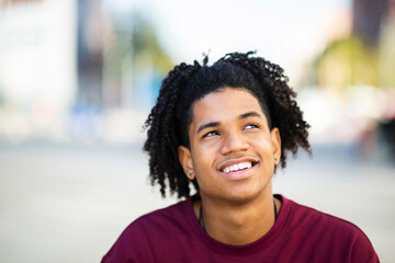 Happy man daydreaming outdoors in city