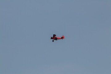 Vintage biplane flying in the cloudless sky