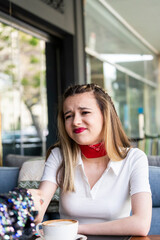 Portrait of young beautiful lady sitting at the restaurant with her friend