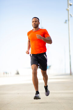 Young fit man jogging in city