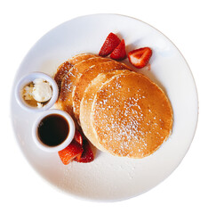 Pancakes with strawberries, maple syrup, and butter on the plate isolated on transparent background