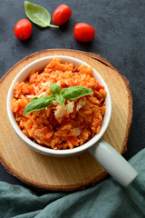 Kritharaki with tomatoes and chicken. Traditional type of Greek pasta shape of rice. Greek version of Italian Orzo