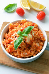 Kritharaki with tomatoes and chicken. Traditional type of Greek pasta shape of rice. Greek version of Italian Orzo