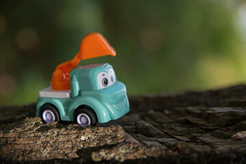 Children's toy car on stones and sand