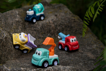 Children's toy car on stones and sand