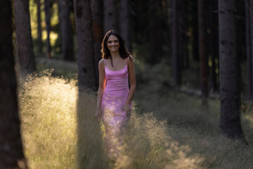 Young, brunette girl walking through the forest