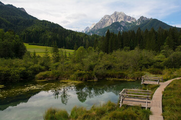 Observation platforms in Zelenci Nature Reserve near Kranjska Gora in north west Slovenia. It is a protected wetland and source of the Sava Dolinka River. The Ponce mountains are in the background
