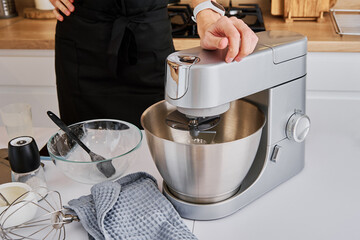 Woman cooking at preparing food, using food processor, Modern appliance for cooking