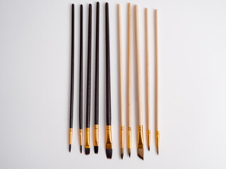 Various artist's brushes on a white background.