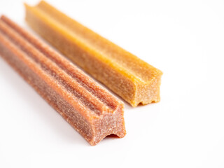 Close up dog tooth stick to reduce tartar buildup isolated on white.