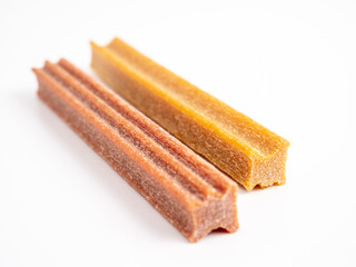 Close up dog tooth stick to reduce tartar buildup isolated on white.
