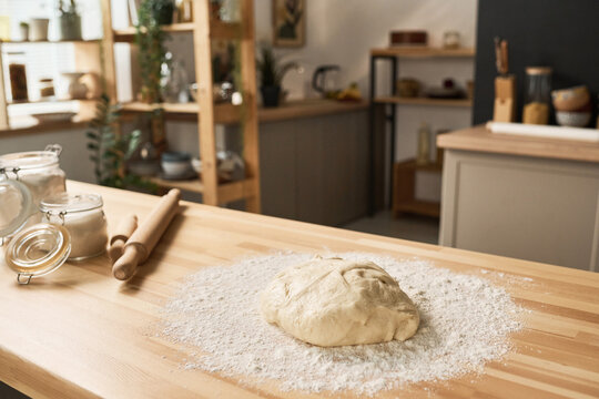 Close-up Of Homemade Dough With Flour On Wooden Kitchen Table At Home