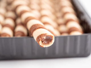 Chocolate wafer sticks or rolls, on a white background.