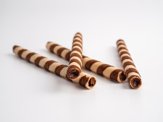 Chocolate wafer sticks or rolls, on a white background.