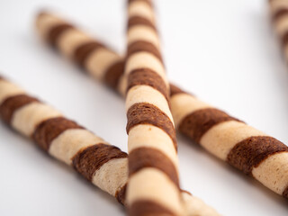Chocolate wafer sticks or rolls, on a white background.