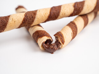 Chocolate wafer sticks or rolls, on a white background.