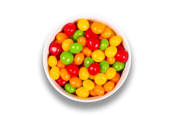 Colorful candy pills in bowl isolated on white background. Top view