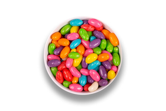 Colorful candy pills in bowl isolated on white background. Top view