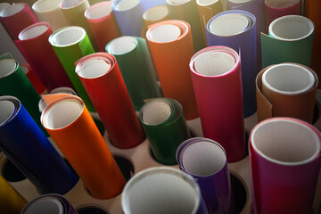 A stand with samples of self-adhesive vinyl film in various colors.Film for advertising design.