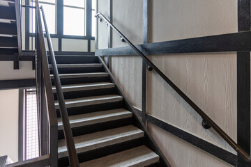 Stainless steel and wood railing. Fall Protection, modern design of handrail and staircase.