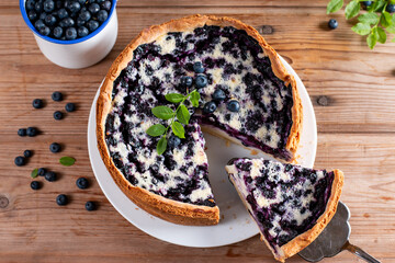 Traditional homemade blueberry pie on wooden table, top view