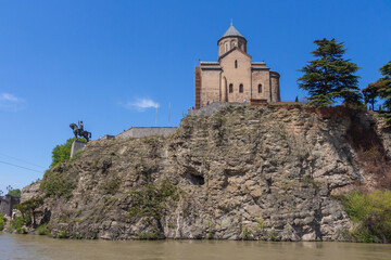 Fototapeta na wymiar A view of the ancient Metekhi Church, built on the banks of the Mtkvari River in Tbilisi. Georgia country