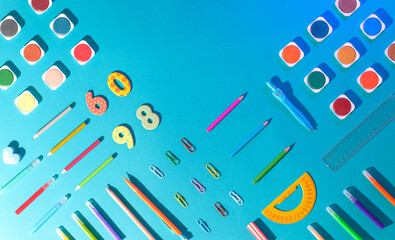 Flat lay with different school supplies on colored background. Copy space. Top view.