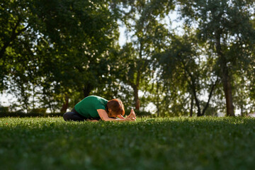 Fototapeta na wymiar Senior woman practicing yoga in knee-head pose