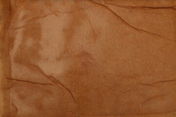 Empty crumpled wet craft paper blank texture copy space wall background. Brown beige color.