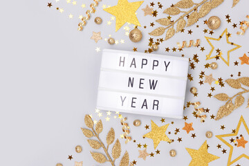 Happy New Year. Lightbox and golden decorations on a blue background with place for text.