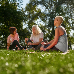 Woman looking at cheerful elderly couple in park