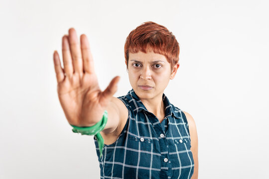 A Mid Age Latin Woman Shows Her Right Hand In A Stop Sign