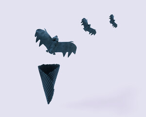 Minimal Halloween concept made of bats flying out of black ice cream cone against isolated pale purple background. invitation card for Halloween party.