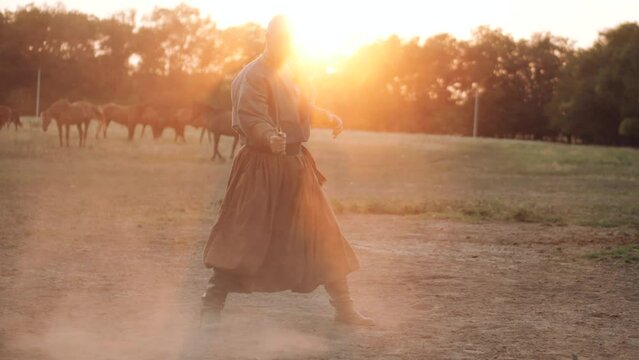 Cossack with a saber in his hands is preparing for battle. Independent Ukrainian people. Patriots of their country. Kievan Rus. Young handsome male Cossack.