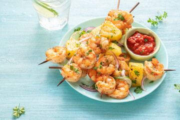 kebab skewers of barbecued shrimp with a pineapple