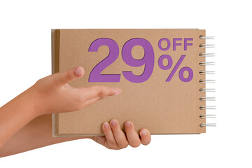 29 percent discount on isolate. Notepad from recycled paper in the hands of a child with text, sale up to 29 percent. The child is holding a notepad demonstrating a big sale.