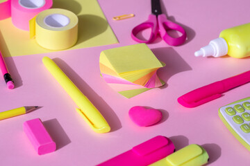 Yellow-pink school and office supplies on a yellow-pink background