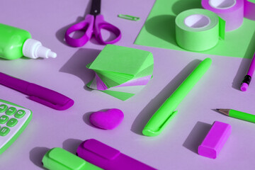Purple-green school and office supplies on a purple-green background