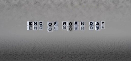end of work day word or concept represented by black and white letter cubes on a grey horizon background stretching to infinity