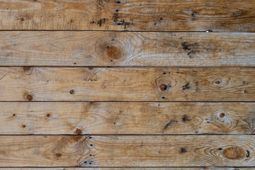 Vintage gray wood background texture with knots and nail holes. Brown abstract background. Vintage wooden dark boards. Front view with copy space.