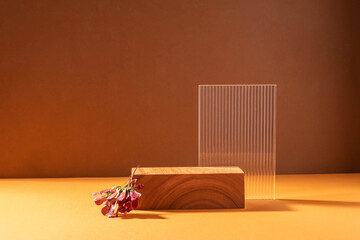 Creative abstract podium from wooden figures and glass, against a brown background with hard light