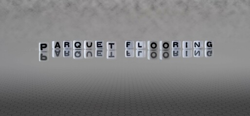 parquet flooring word or concept represented by black and white letter cubes on a grey horizon background stretching to infinity